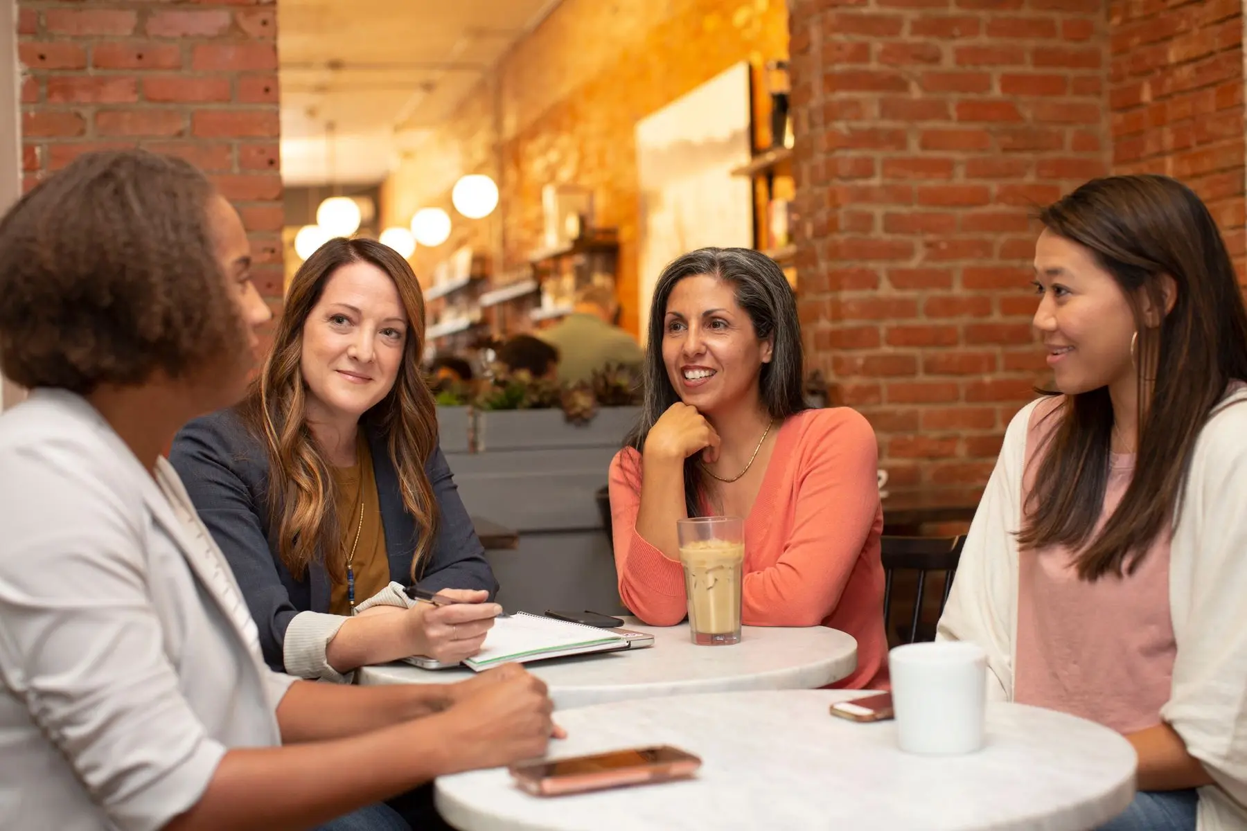 A diverse group of women sharing a thoughtful conversation