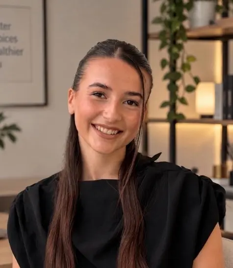 Portrait of Saša Nikić smiling, wearing a black top